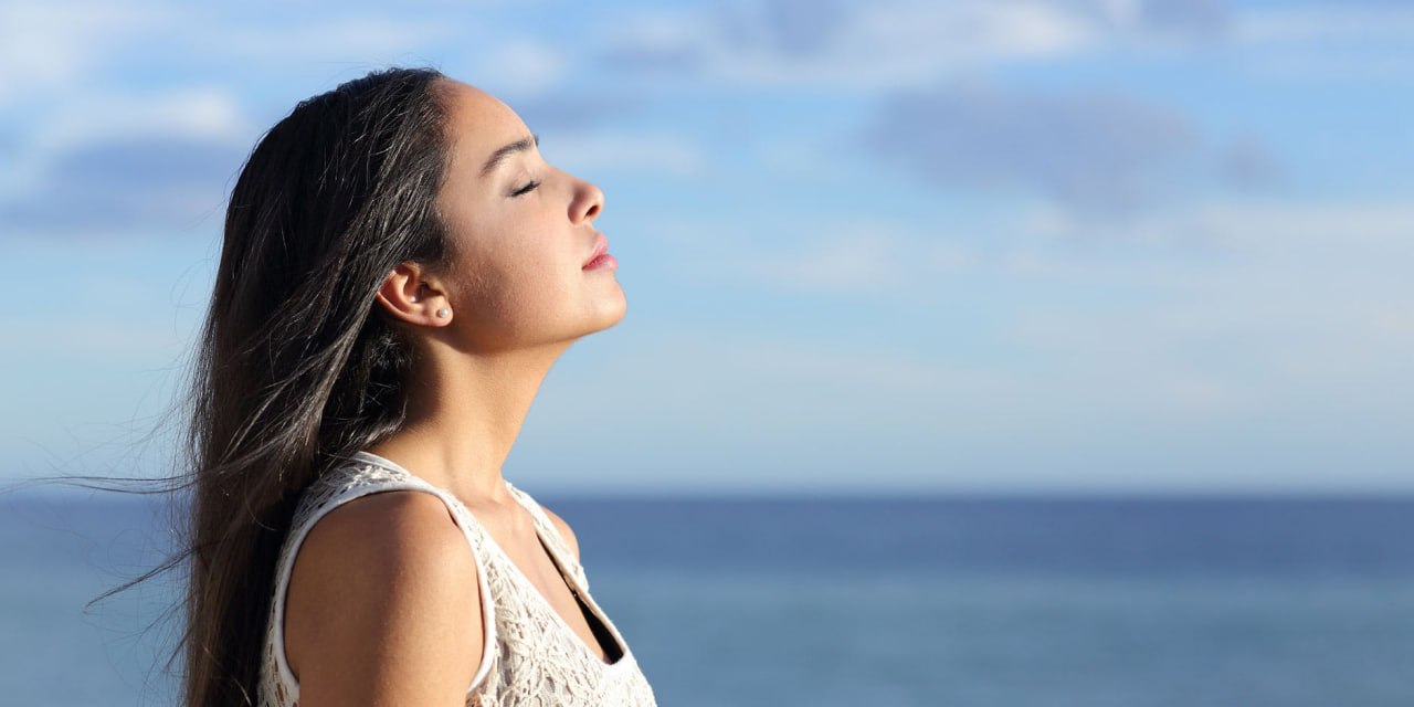 Breathing Exercise - Woman Breathing Deeply at Sunset